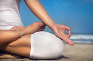 Meditation mudras on the beach for mindfulness and relaxation.