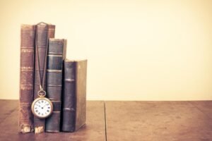 Books and a pocket watch symbolizing time and reality exploration.