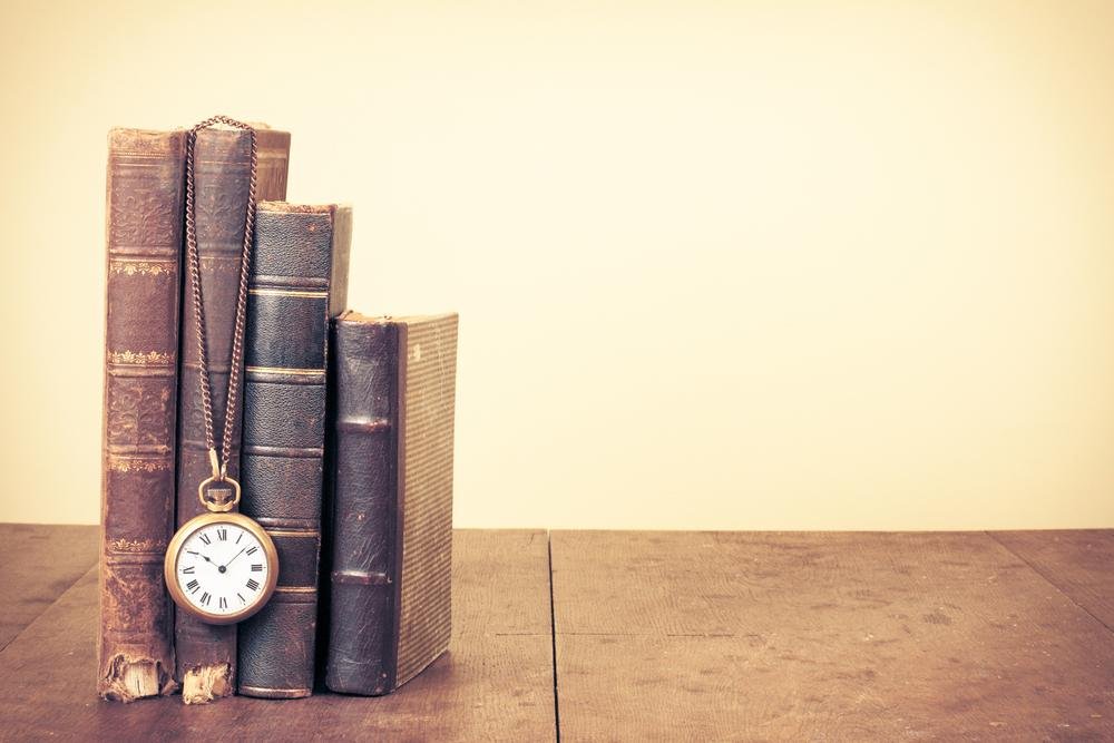 Books and a pocket watch symbolizing time and reality exploration.