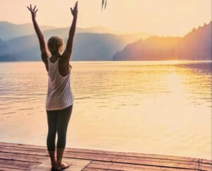 Joyful yoga for neck and back wellness by the tranquil lake.