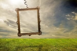 A decorative frame suspended in serene, open nature under a dramatic sky.