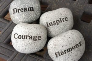 Inspirational stones with the words dream, inspire, courage, and harmony.