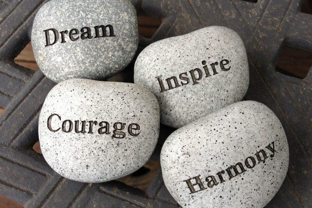 Inspirational stones with the words dream, inspire, courage, and harmony.