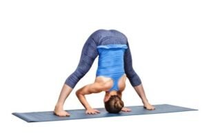 Yoga pose: forward bend in blue outfit, enhancing flexibility and strength.