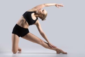 Strong woman practicing a creative yoga pose for flexibility and strength.