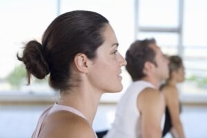 Yoga participants focused in a serene studio environment.