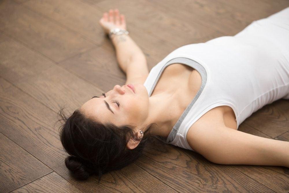 Relaxing yoga meditation on wooden floor for stress relief and mindfulness.