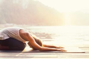 Sunrise yoga by the water promotes relaxation and mindfulness.