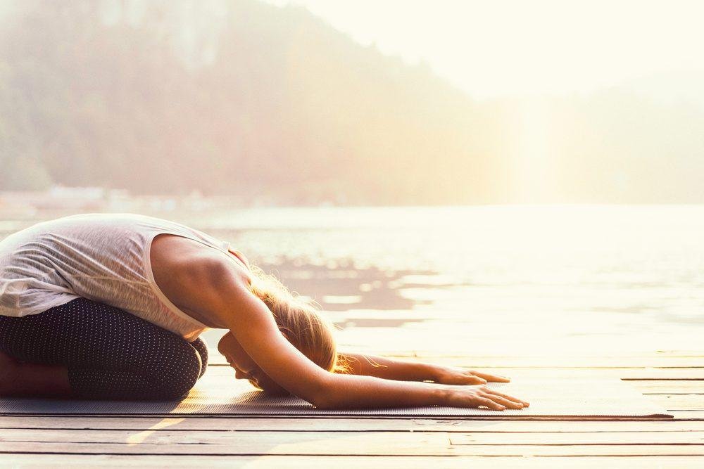 Sunrise yoga by the water promotes relaxation and mindfulness.