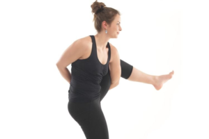 Woman practicing a challenging yoga pose for strength and flexibility.