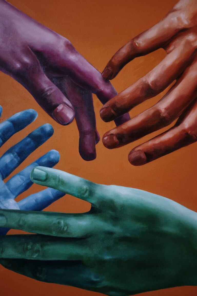 Colorful hands reaching out on a vibrant background.