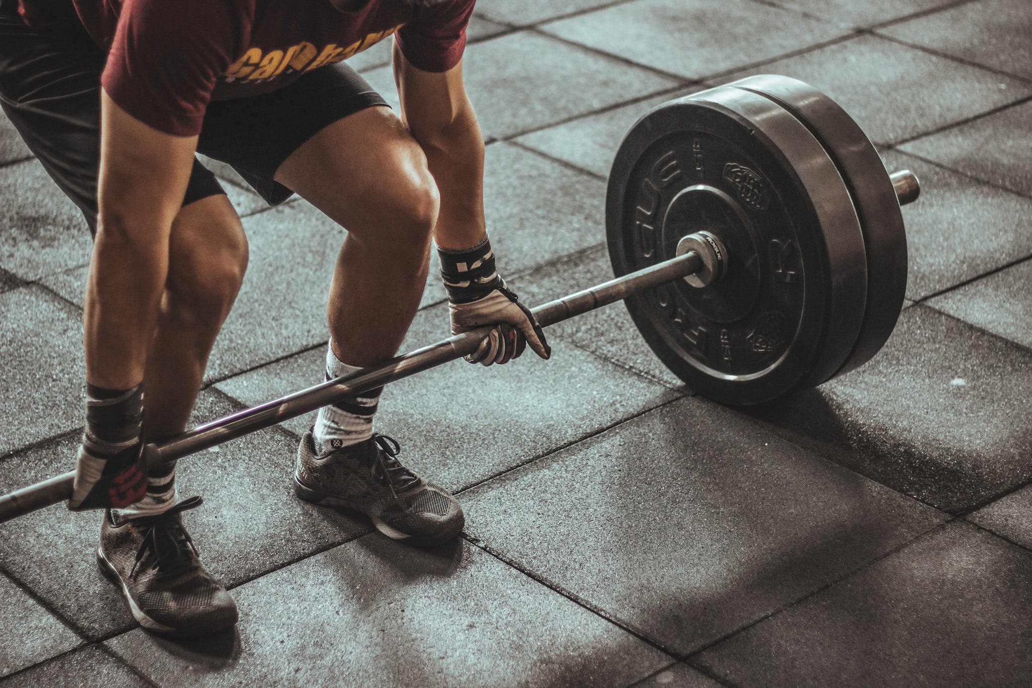 Lifter preparing to lift a heavy barbell in a gym setting.