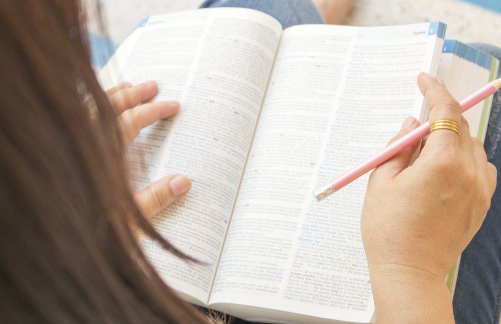 A person writing on a piece of paper

Description automatically generated with medium confidence