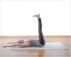 Yoga leg raise exercise for core strength and flexibility improvement.