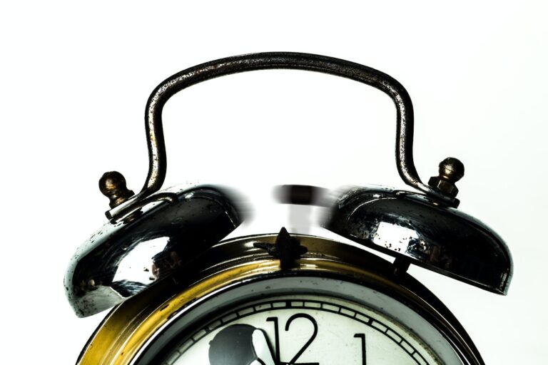 Classic black bell alarm clock close-up with vintage design.