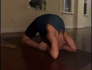 Deep stretching yoga pose for flexibility and relaxation.
